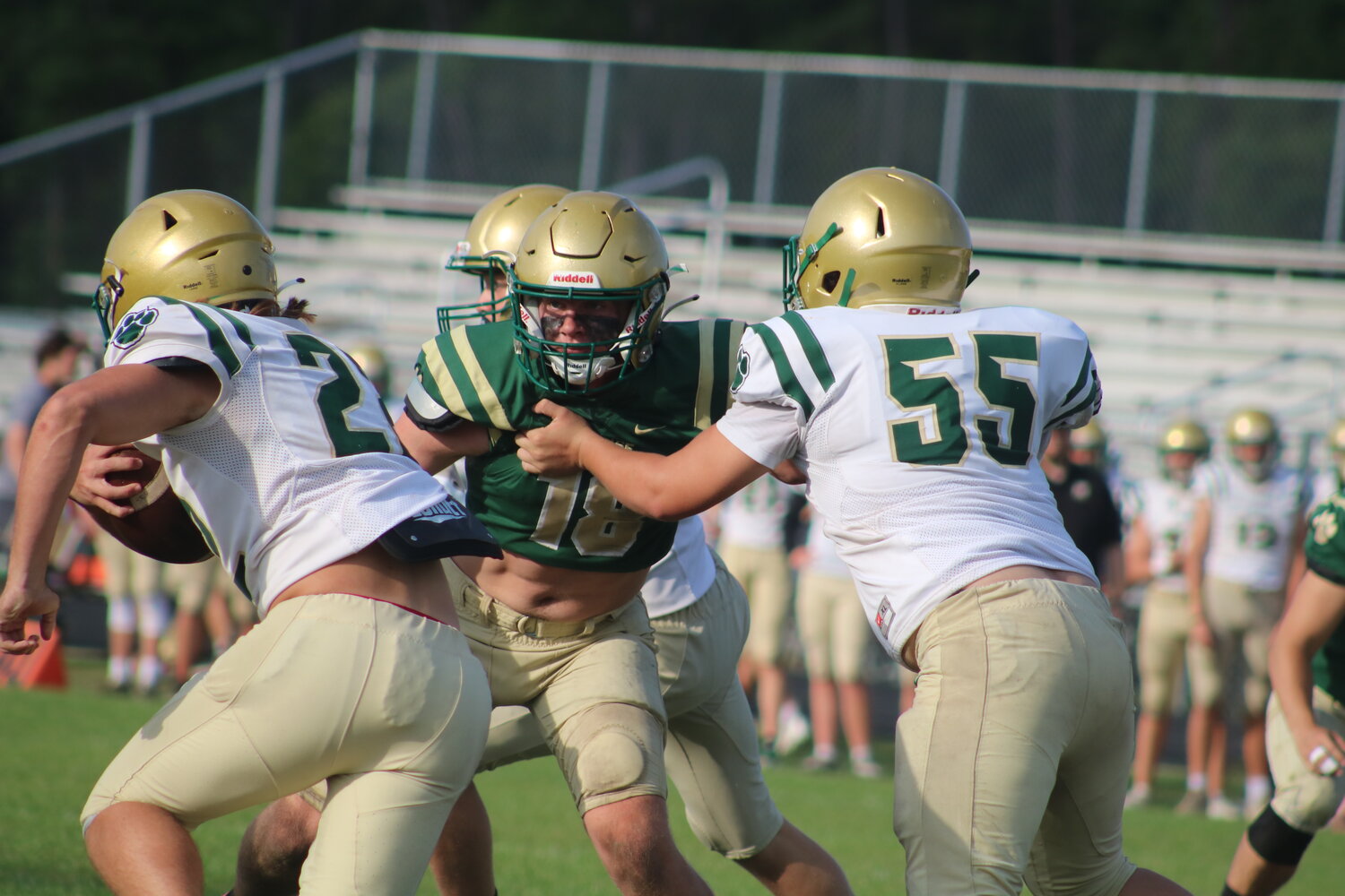 Peyton Mooningham (No. 18) fights through a block and looks to meet the ball carrier in the backfield.